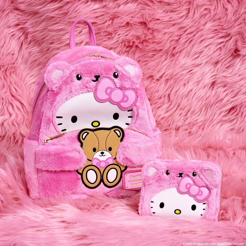 Image of our exclusive Hello Kitty Plush Bear Mini Backpack and Wallet sitting against a plush pink background